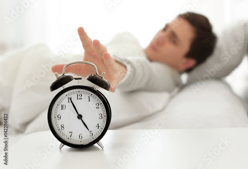 Young man switching off ala...