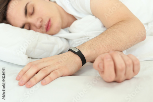 Young man with sleep tracke...