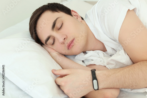 Young man with sleep tracke...