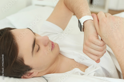 Young man with sleep tracke...