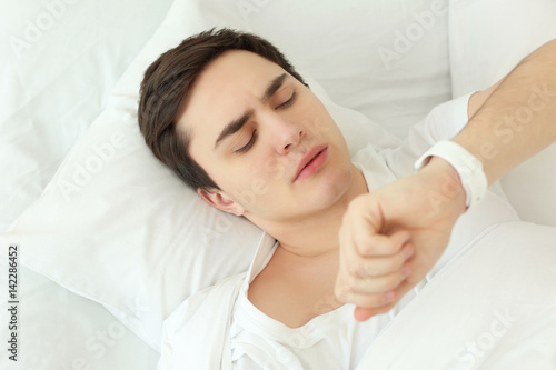 Young man with sleep tracke...