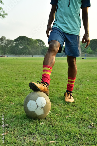 Soccer player standing with ball