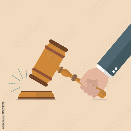 Hand holding judges gavel