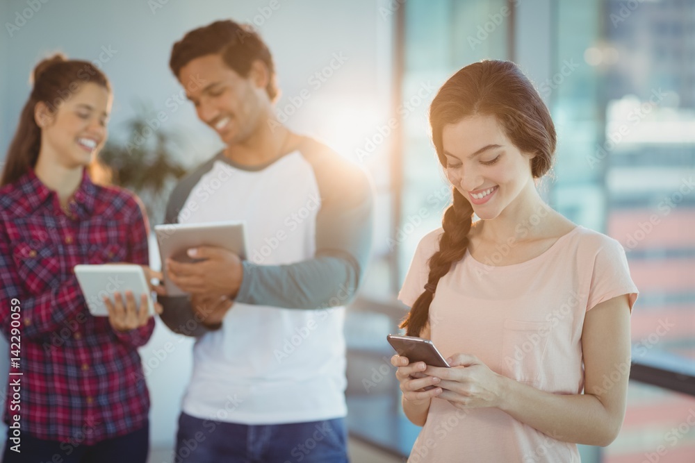 Business executives using mobile phone and digital tablet Business executives using mobile phone and digital tablet