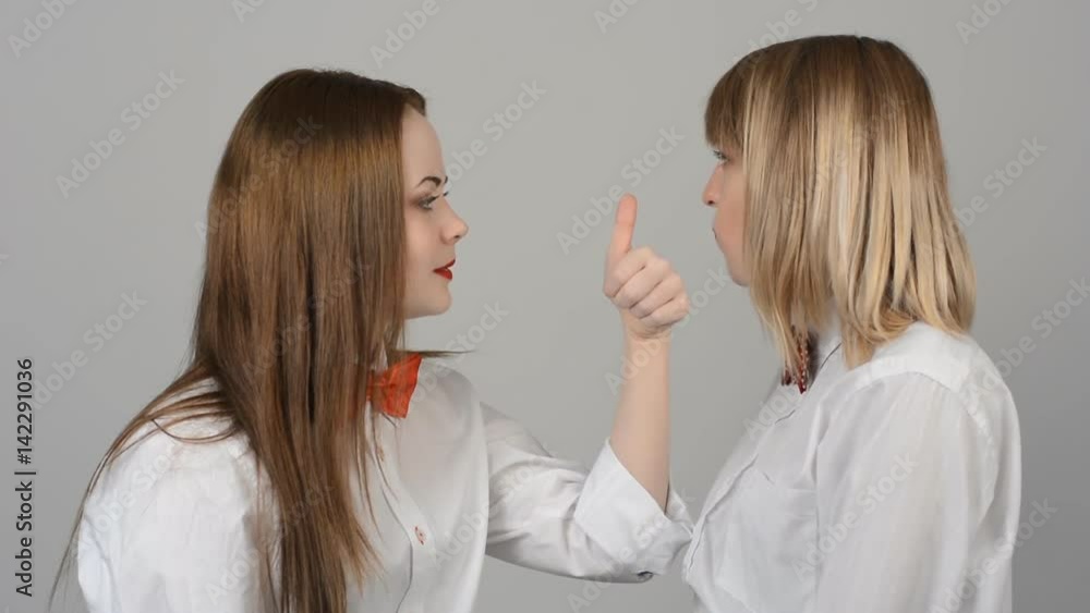 Portrait of two beautiful young women with butterflies on their neck smiling, emotions. Leading, entertainer in the studio Portrait of two beautiful young women with butterflies on their neck smiling, emotions. Leading, entertainer in the studio