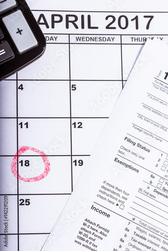 1040 tax return with calender and the 18th circled in red