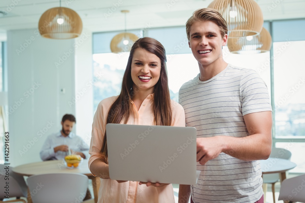 Portrait of business executives using laptop Portrait of business executives using laptop