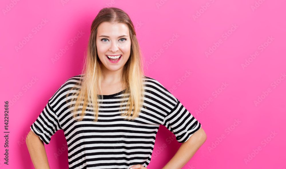 Happy young woman with pink background Happy young woman with pink background