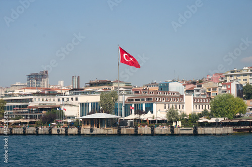 Cityscape with Turkish flag over clear sky on the background