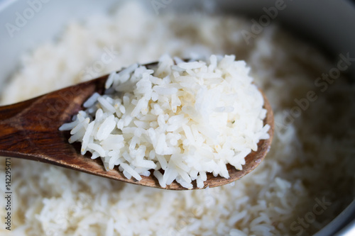 Cooked rice in pot with wood ladle