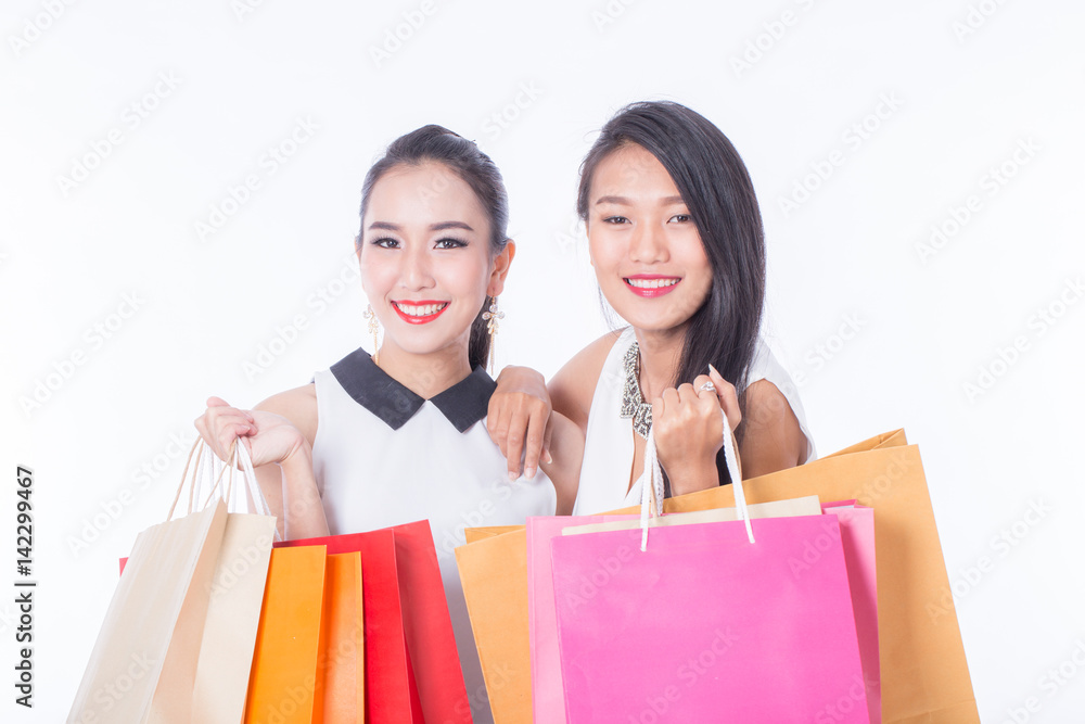two women holding shopping bag isolated on white background two women holding shopping bag isolated on white background