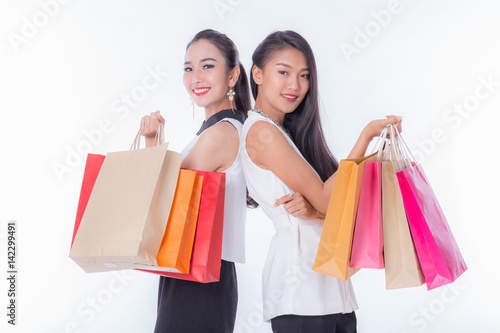 two women holding shopping bag isolated on white background
