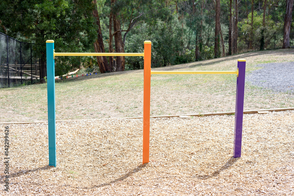 Little colourful horizontal bar in childrens play area in the park.