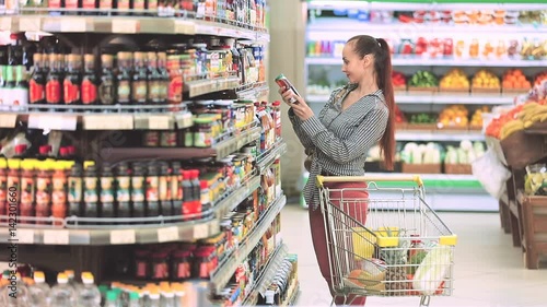 Wallpaper Mural Woman chooses juice in the supermarket Torontodigital.ca