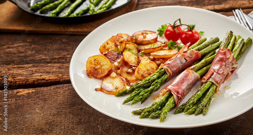 Meal of asparagus, poscuitto and potatoes on plate Meal of asparagus, poscuitto and potatoes on plate