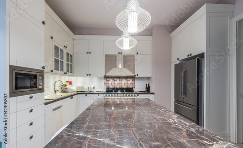 Kitchen island in modern new kitchen interior photo