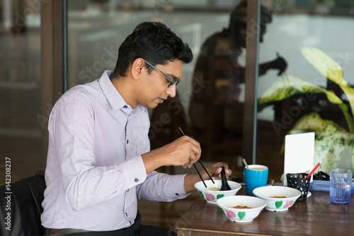 Photography indian business male eating noodle