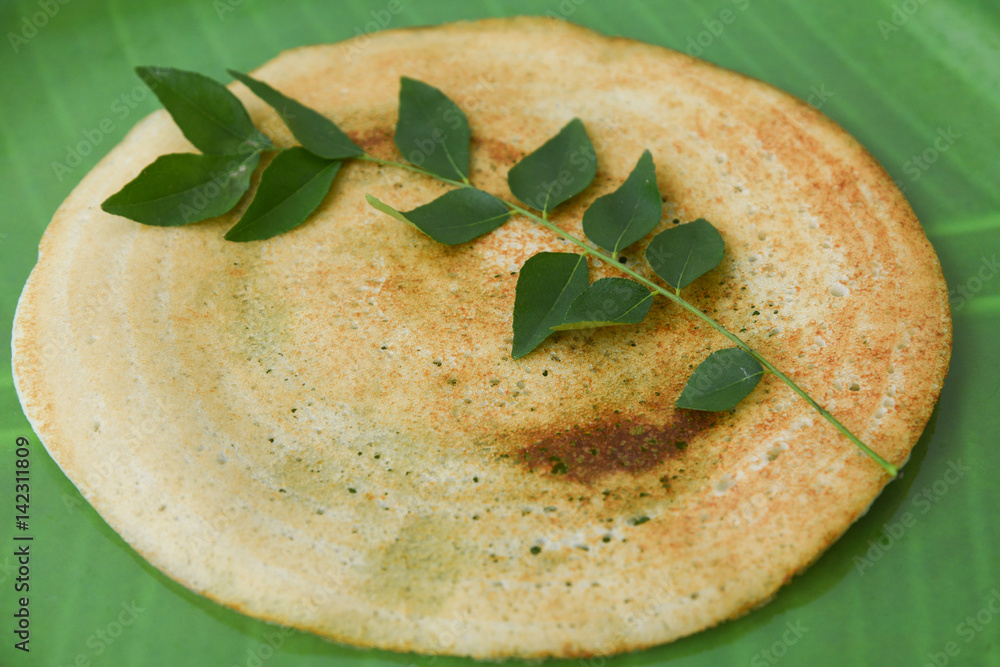 Dosa and Coconut chutney with fresh raw coconut cut in half with