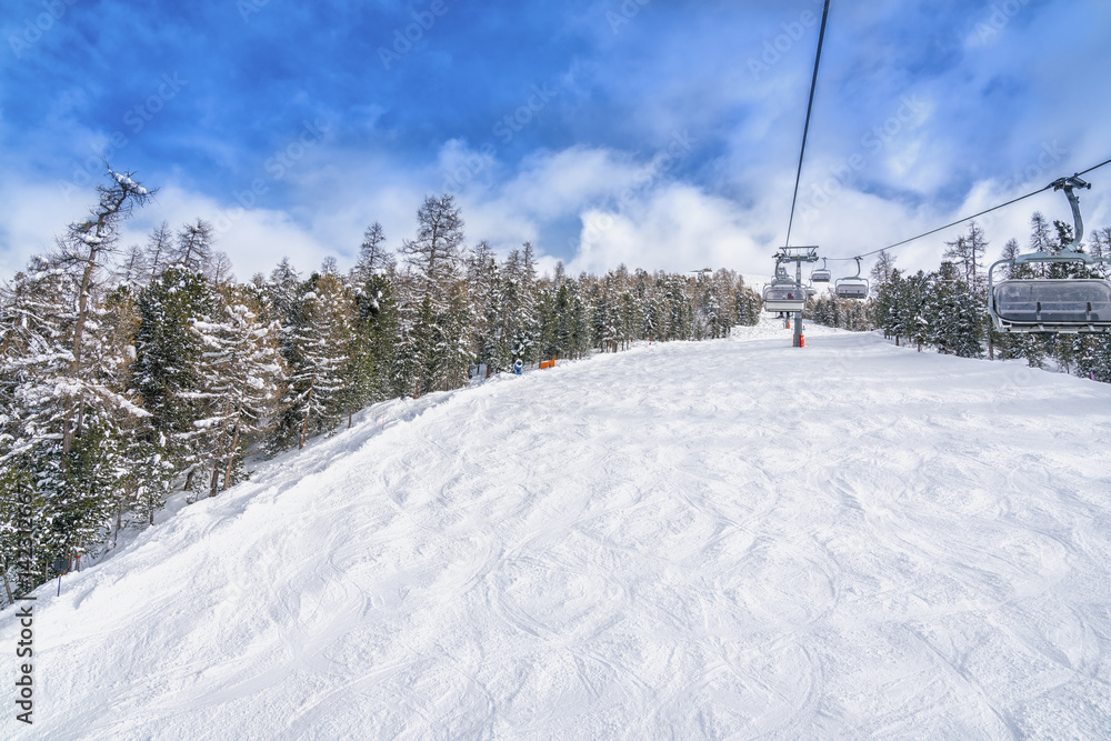 Empty ski slope, winter landscape with ski lift Empty ski slope, winter landscape with ski lift