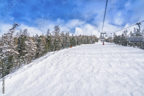 Empty ski slope, winter landscape with ski lift © marchello74