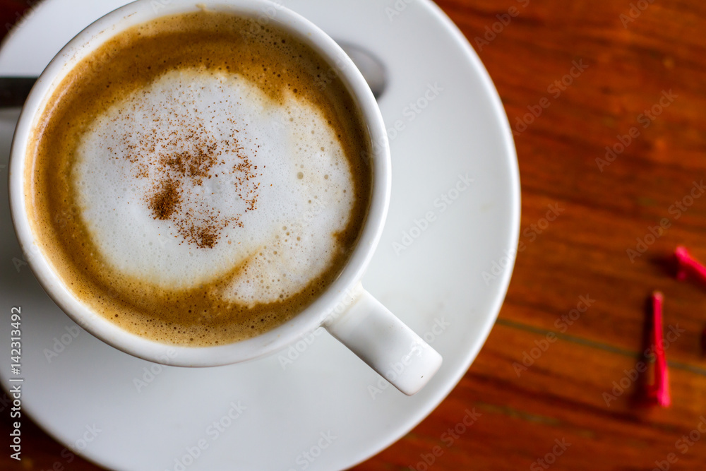 Hot coffee in cup on wooden table Hot coffee in cup on wooden table