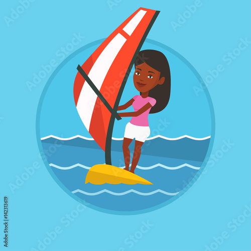 Young woman windsurfing in the sea.