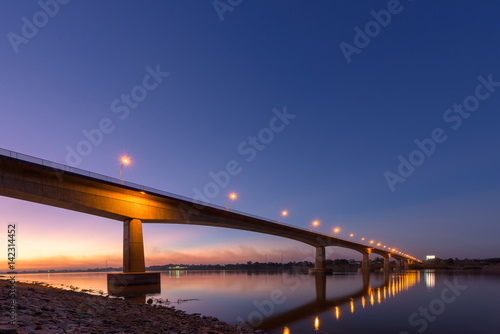 Fototapeta Naklejka Na Ścianę i Meble -  Bridge across the Mekong River at sunset. Thai-Lao friendship bridge at Nong Khai, Thailand