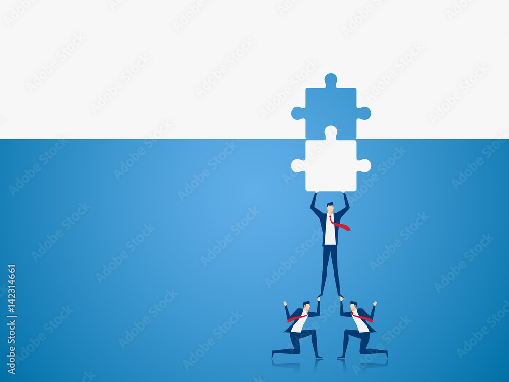 Business team places the final piece of a puzzle.Team support and help concept. Business team places the final piece of a puzzle.Team support and help concept.