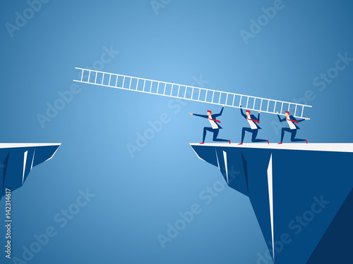 Business team using ladder to cross through the gap between hill. Business Teamwork ,risk and success concept.