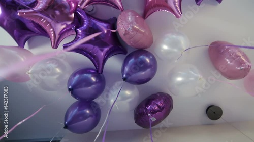 Beautiful purple and pink baloons on the ceiling. slow motion photo