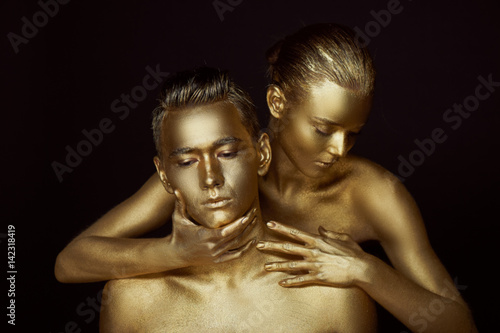 A girl and a boy, covered in gold paint. With my eyes closed. She bent down to him. Look in different directions. The fragmentation of interests