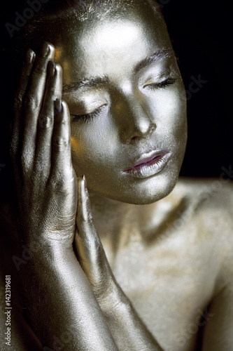 Portrait unearthly Golden girls, hands near the face. Very delicate and feminine. The eyes are closed