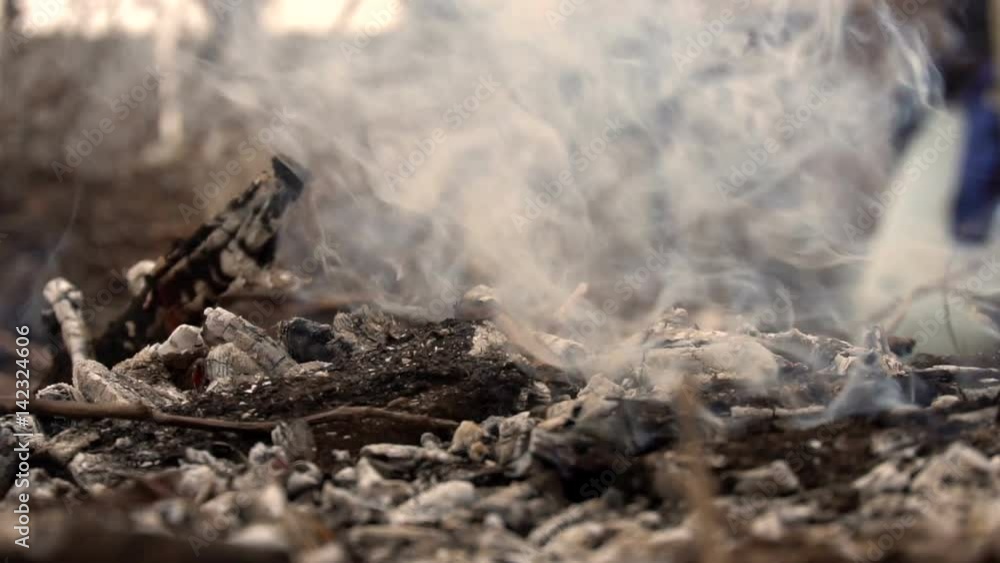 Smoldering remains from the campfire. Slow motion Smoldering remains from the campfire. Slow motion