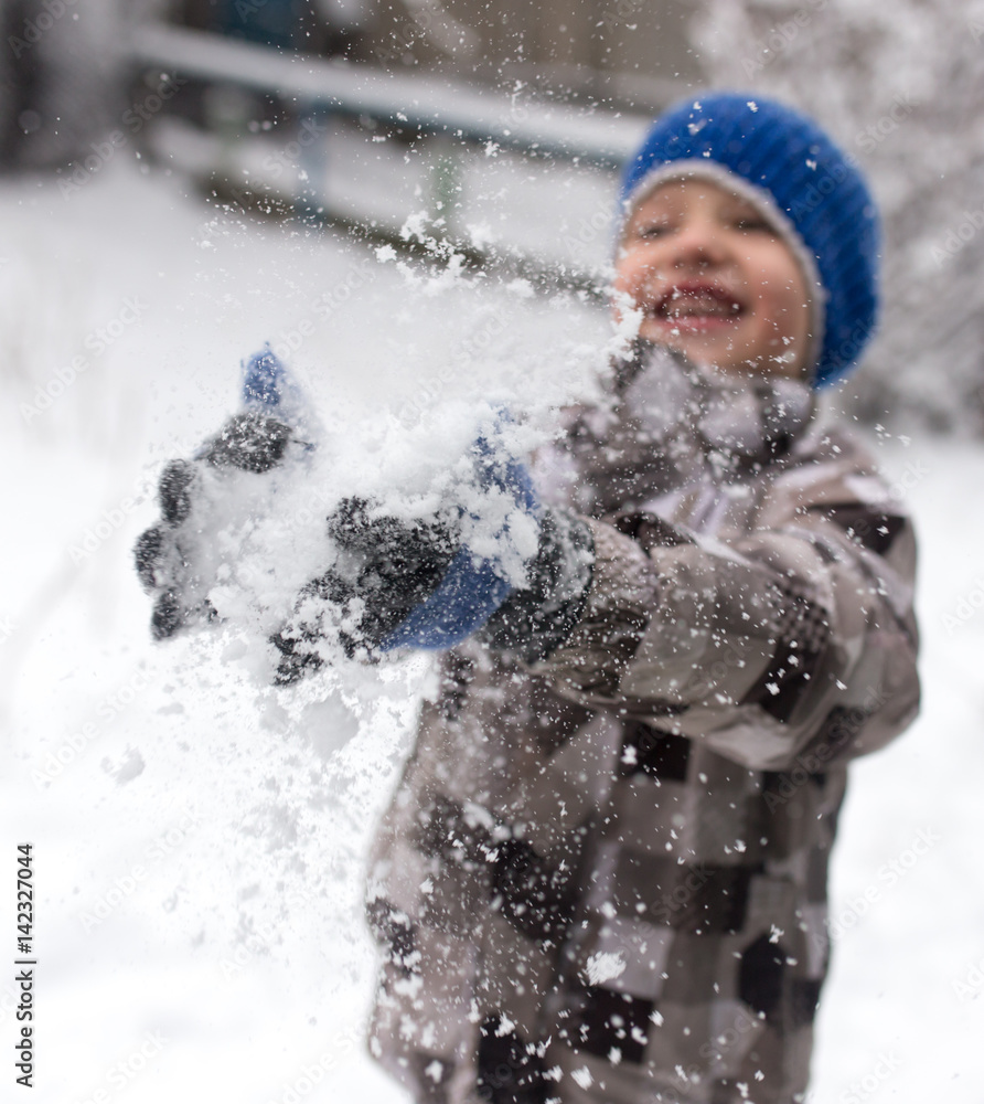 Boy playing with snow in winter Boy playing with snow in winter
