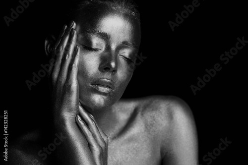 Portrait unearthly Golden girls, hands near the face. Very delicate and feminine. The eyes are closed.Black and white