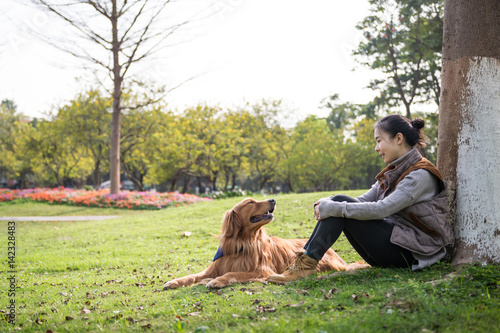 Girl and Golden Retriever, outdoors on the grass © chendongshan