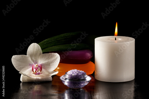 Orchid flower  candle  soap and sea salt for spa procedures on black background