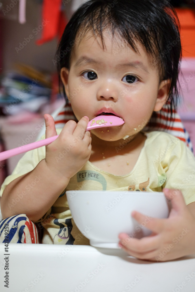 Happy baby eating himself. Asian cute baby eating food. Happy baby eating himself. Asian cute baby eating food.