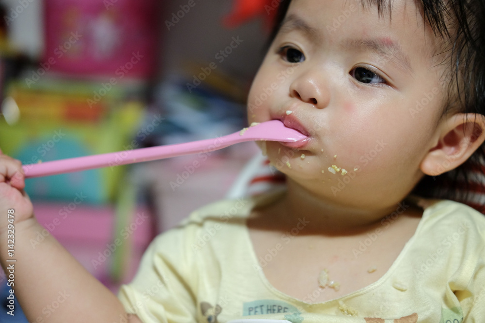 Happy baby eating himself. Asian cute baby eating food. Happy baby eating himself. Asian cute baby eating food.