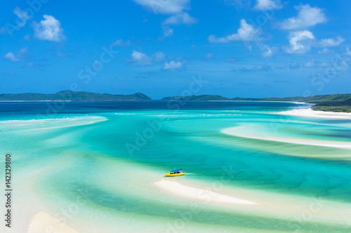 Bright yellow boat on tropical island beach