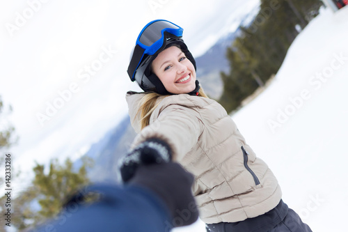 Beautiful young woman having fun over winter background.