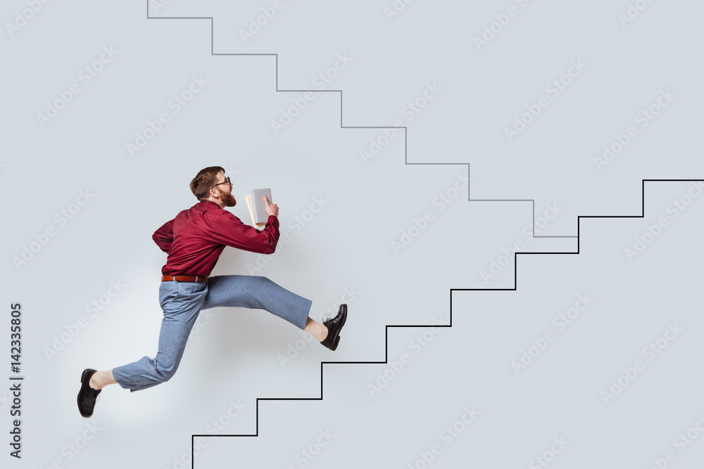 Young bearded man with books running up a drawn stairs Young bearded man with books running up a drawn stairs