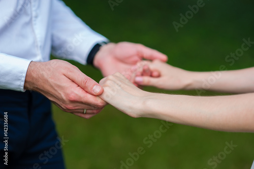 Bride and groom holding hands © fotofrol