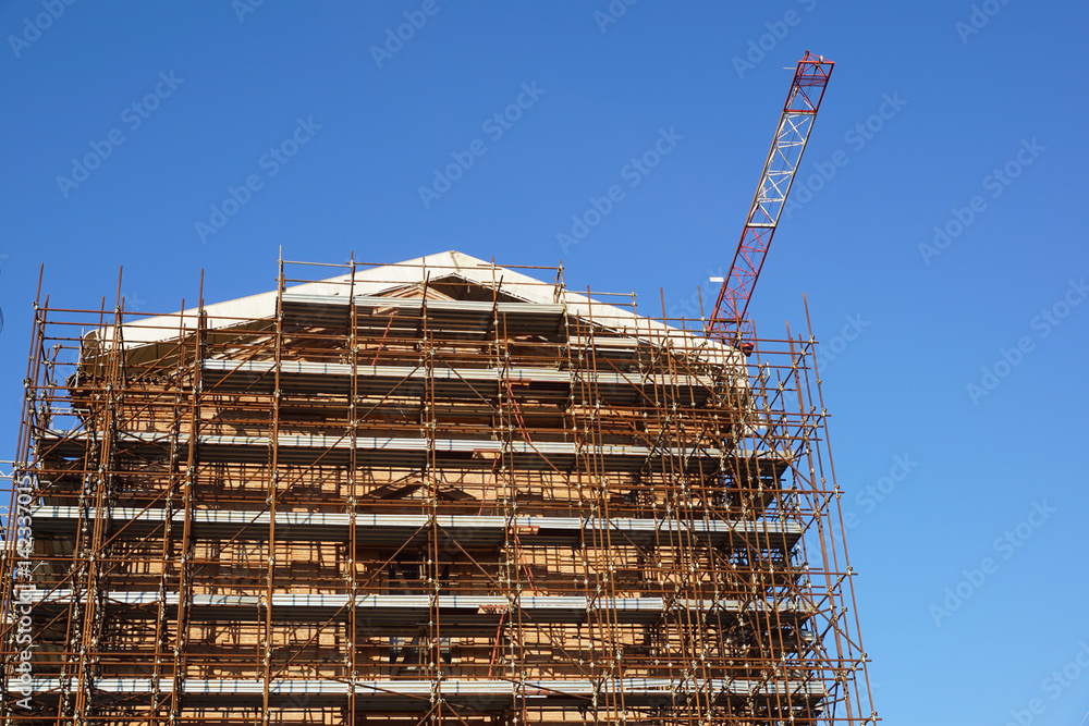 Extensive scaffolding providing platforms for work in progress on a church in restructuring