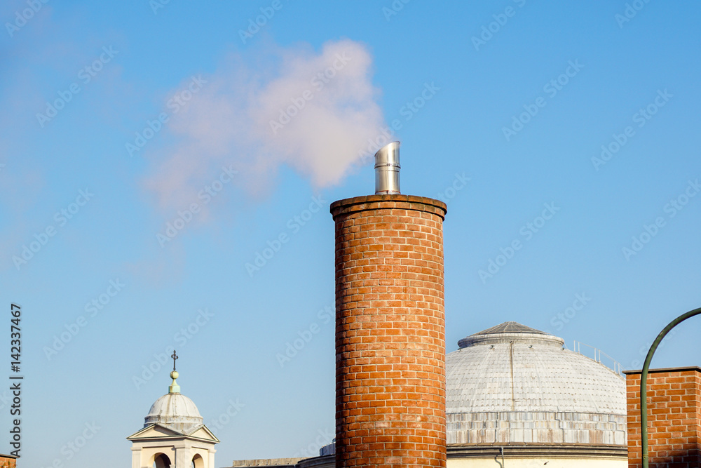 close up of beautiful arabesque white chimney on the roof rising up in blue sky,