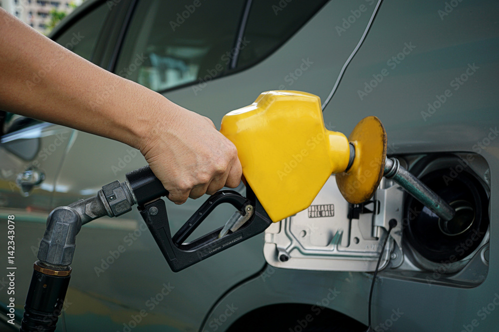 Handle fuel nozzle to refuel. Vehicle fueling facility. Handle fuel nozzle to refuel. Vehicle fueling facility.