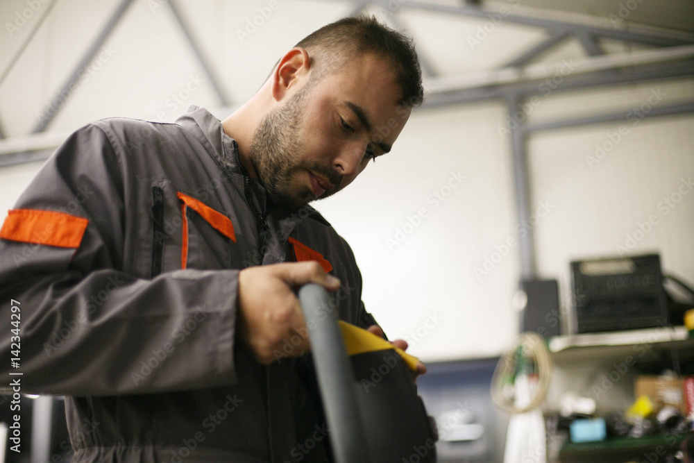 Young worker in workshop. Young worker in workshop.