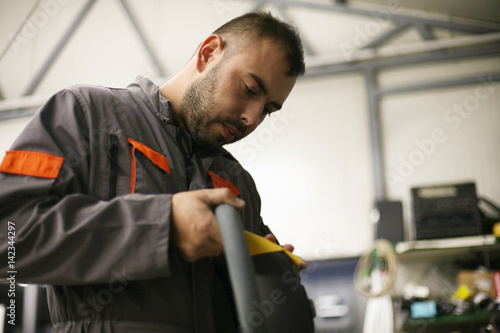 Young worker in workshop.