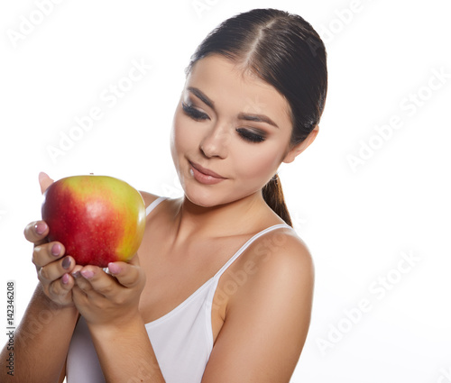 Beautiful close-up portrait of young woman with red apple. Healthy food concept. Skin care and beauty. Vitamins and minerals.