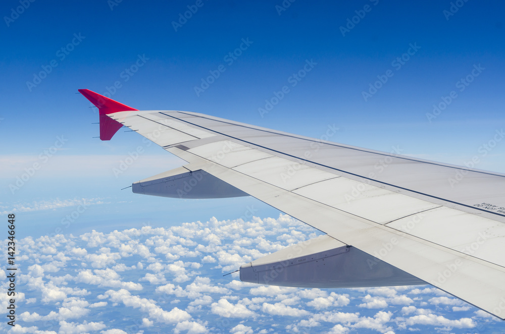 Clouds and sky as seen through window of an aircraft Clouds and sky as seen through window of an aircraft